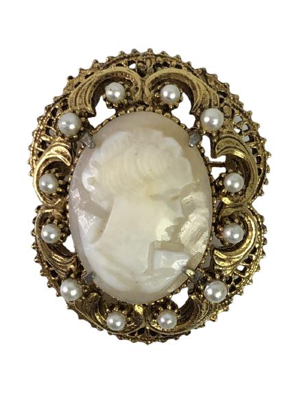 VTG FLORENZA GOLD & PEARL CAMEO BROOCH 1.75": VTG FLORENZA GOLD & PEARL CAMEO BROOCH 1.75" - IVORY CAMEO SURROUNDED BY PEARLS IN GOLD FILIGREE SETTING- HAS A HOOK SO IT CAN ALSO BE WORN AS A PENDANT- VERY GOOD VINTAGE CONDITION