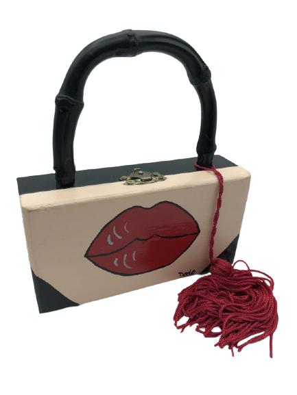 VINTAGE WOODEN BOX BAG WITH PAINTED LIPS 3" HIGH: VINTAGE WOODEN BOX BAG WITH PAINTED LIPS 3" HIGH HANDBAG UNIQUE TOP HANDLE FUN6" X 1.5" X 3" BLACK WOOD BODY WITH RED PAINTED LIPS ON PEACH BACKGROUNDBLACK BAMBOO TOP HANDLE WITH RED TASSLEBLACK BLING