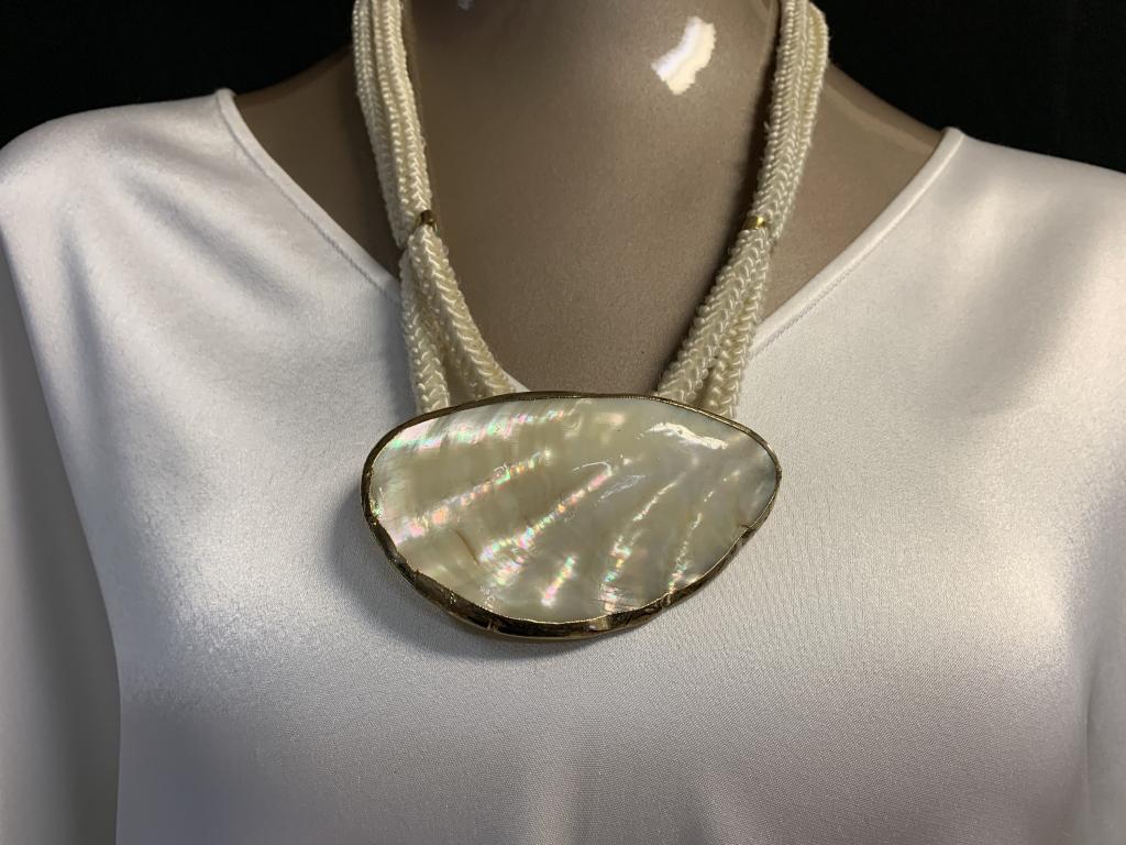 LAGERFELD / TIZIANI WHITE OYSTER SHELL NECKLACE: RARE VINTAGE LAGERFELD / TIZIANI 1960'S COLLECTIBLE WHITE OYSTER SHELL MOTHER OF PEARL STYLE NECKLACE ON BRAIDED SYNTHETIC ROPE CHAIN- 13" APPROX TOTAL ( SHELL IS 2" X 3" )- VERY GOOD CONDITION CONSIS