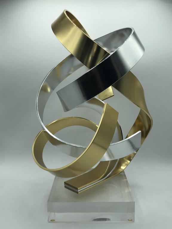 VTG D. MURPHY ABSTRACT METAL SCULPTURE ON LUCITE: VTG D. MURPHY ABSTRACT METAL SCULPTURE ON LUCITE - SIGNED BY THE ARTIST DAN MURPHY 1987- 15" HIGH X 6"- GOLD & SILVER WIDE SWIRL PATTERN- VERY GOOD CONDITIONCOLLECTIBLE ART; CONTEMPORARY DESIGN; SCULP