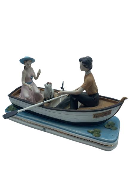 CAPODIMONTE GIRL AND BOY W/ DOG IN A BOAT 17": CAPODIMONTE GIRL AND BOY W/ DOG IN A BOAT 17" -11" X 17' X 7"- VERY GOOD CONDITION CONSISTENT WITH AGE AND USE-HPG11221
