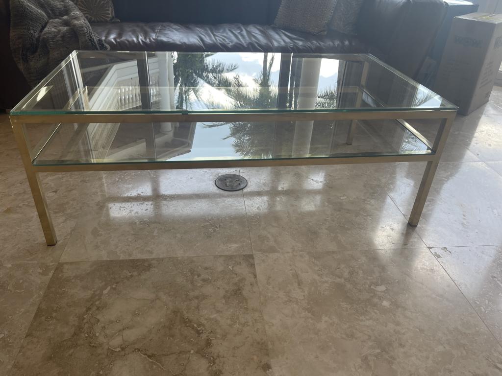 HILDA FLACK DESIGNER GOLD AND GLASS COCKTAIL TABLE: HILDA FLACK DESIGNER GOLD AND GLASS COCKTAIL TABLE-18 X 51 1/2 X 29-VERY GOOD CONDITION THIS ITEM IS LOCATED OFF-SITE. All items must be picked up by confirmed appointment on Friday, May 6th or&