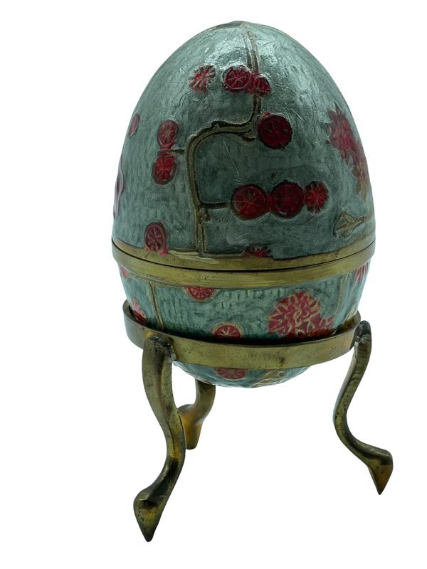 ENAMELED BRASS EGG ON HOLDER 5": ENAMELED BRASS EGG ON HOLDER | ASIAN CHINOISERIE COLLECTIBLE FIGURINES COLISSONE STYLE HOME DECOR-5" TOTAL HEIGHT-GOOD PRE OWNED CONDITION, WEAR-DP7522 THIRD PARTY SHIPPING REQUIRED ON ALL ITEMS. A li