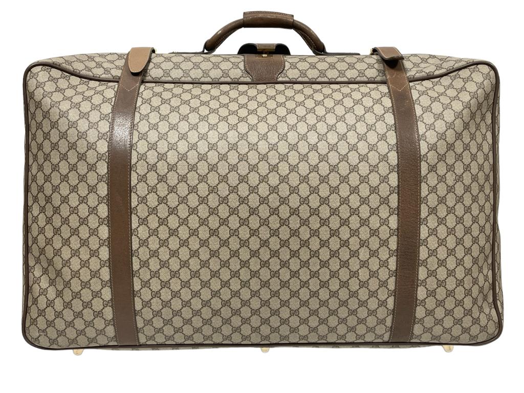 VINTAGE GUCCI LARGE LUGGAGE SUITCASE 30": VINTAGE GUCCI GUCCISIMA LARGE LUGGAGE SUITCASE WEB DESIGN WITH BROWN LEATHER ACCENTS-30" X 22" X 8" APPROX-MADE IN ITALY-PRE OWNED CONDITION, MINOR WEAR, ONE STRAP HAS BEEN REPLACED, SEE ALL PHOTOS-DP