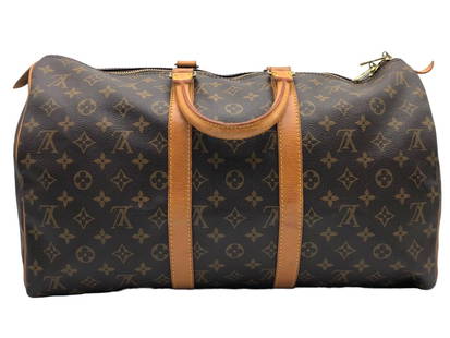 LOUIS VUITTONMONOGRAMMED KEEPALL TRAVEL BAG 55: LOUIS VUITTON KEEPALL 55 BROWN MONOGRAM CANVAS TRAVEL BAG -21.5*11*10 IN -MI1910 (NOVEMBER 1990)-AAX4315 -CONDITION RATING AB -BOX 7 -ALL BAGS HAVE BEEN AUTHENTICATED Bidders may pick up their items f