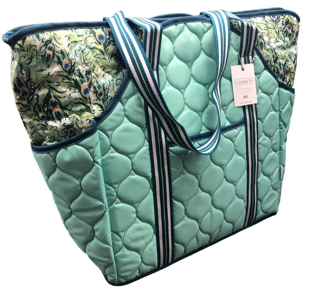 NEW WITH TAG CINDA B QUILTED TOTE BAG: NEW WITH TAG CINDA B QUILTED TOTE BAG -EXTRA POCKETS FRONT AND BACK -ZIPPER AND ZELCRO CLOSURE -SIZE 19"W X 14.5"H X 5.5"D -DG0624 Bidders may pick up their items from the auction-house or have their 