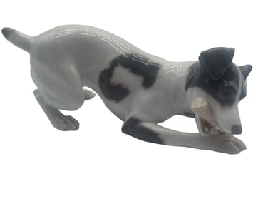 ROYAL COPENHAGEN DOG PLAYING WITH A BONE