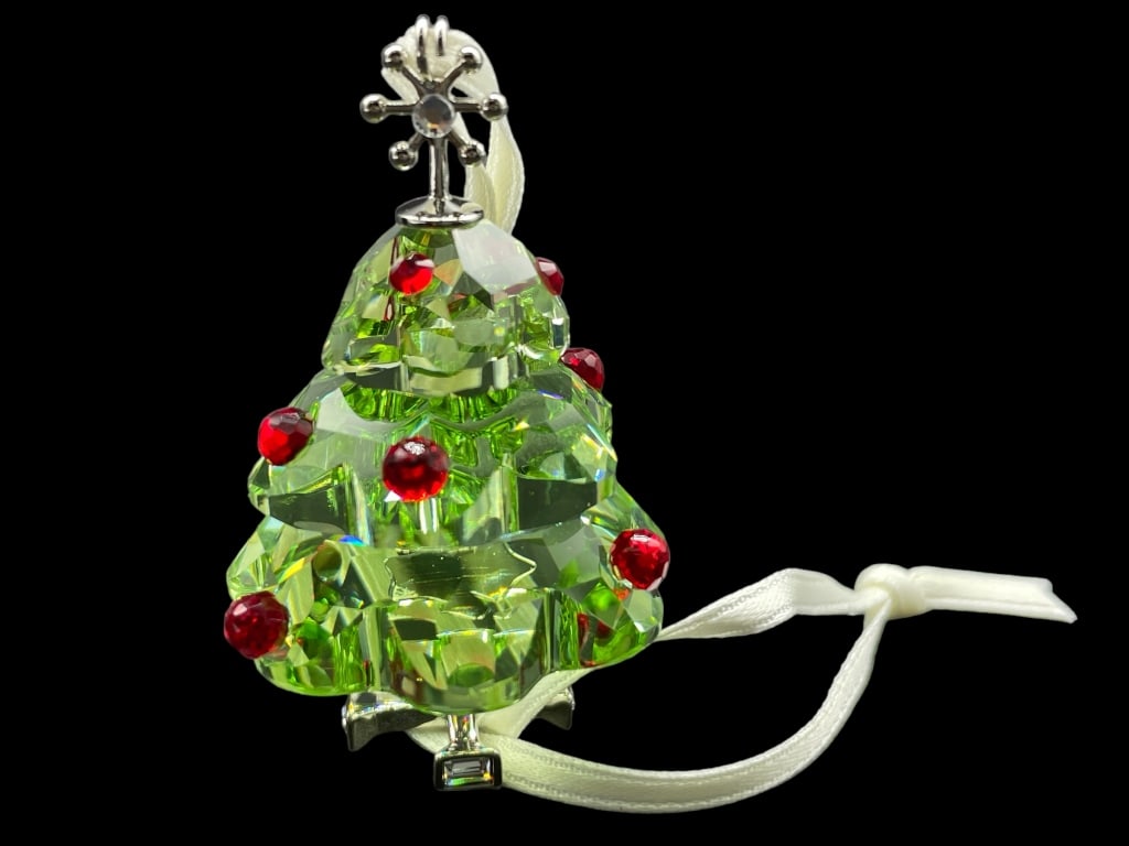 NEW SWAROVSKI CHRISTMAS TREE ORNAMENT: NEW SWAROVSKI CHRISTMAS TREE ORNAMENT -NEW WITH BOX -SIZE 1 3/4" APPROX Bidders may pick up their items from the auction-house or have their items shipped. Some items qualify for in-house shipp