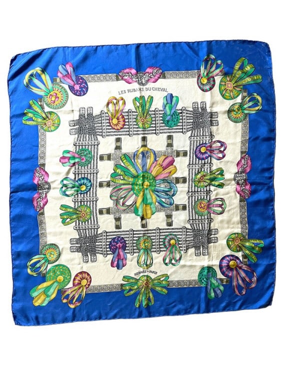 HERMES LES RUBANS DU CHEVAL SILK SCARF 33": HERMES LES RUBANS DU CHEVAL SILK SCARF -BLUE WHITE AND GOLD WITH EQUESTRIAN RIBBONS ACROSS WHITE BACKGROUND WITH ROYAL BLUE BORDER DESIGNED 1993 BY JOACHIM METZ -VERY GOOD PRE OWNED CONDITION -DP82224