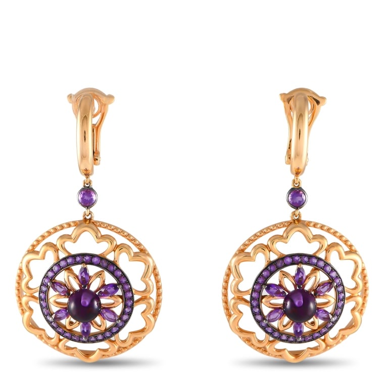BUCHERER 18K ROSE GOLD AMETHYST DROP EARRINGS: Prepare to be impressed by this pair of drop earrings from Bucherer. Clad in 18K rose gold, these earrings feature a mandala-like drop detailed with a round, black rhodium-plated floral frame adorned