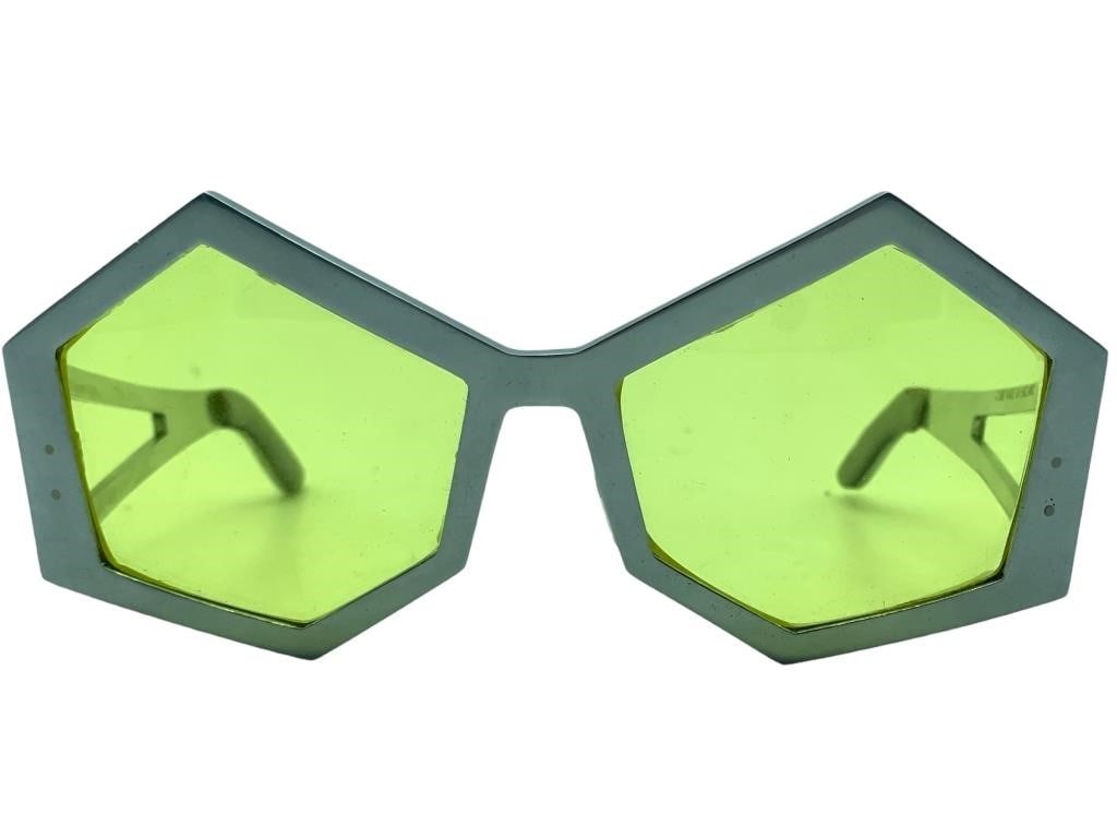NEW! ORA POST MODERN METAL SUNGLASSES: ORA POST MODERN METAL SUNGLASSES WITH AMBER YELLOW TINT LENS -MADE IN ENGLAND -ORIGINAL MSRP $775 -NEW UNUSED CONDITION, MINOR SEPERATION NEAR EAR ARM