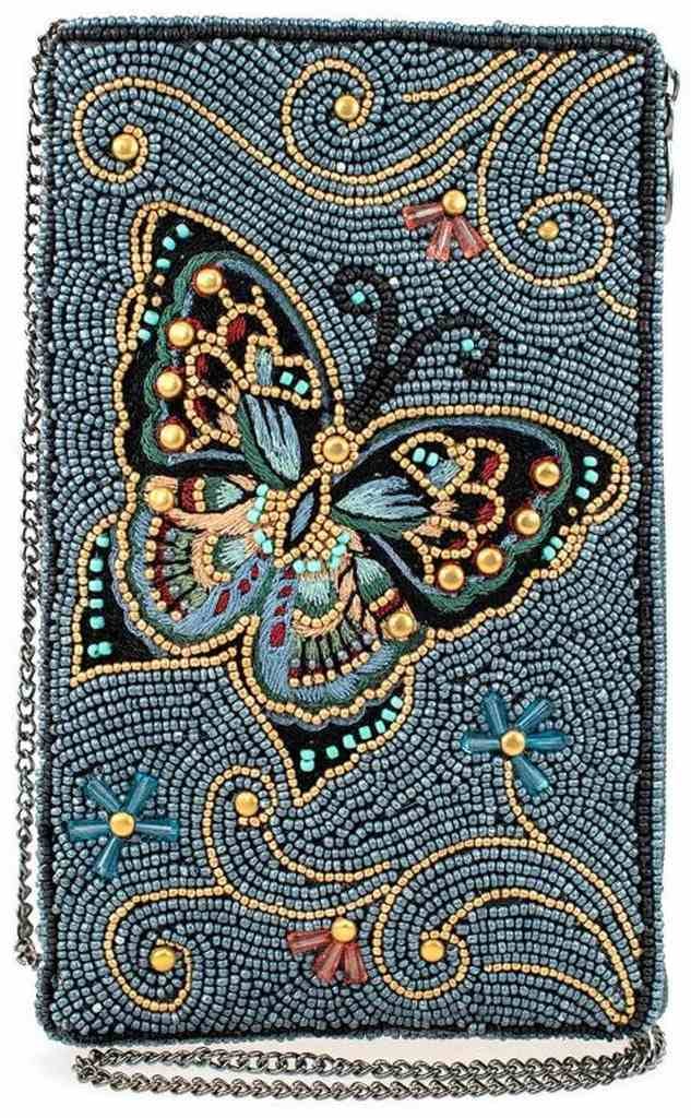 NEW MARY FRANCES MARIPOSA CROSSBODY HANDBAG: NEW MARY FRANCES MARIPOSA CROSSBODY HANDBAG -Embrace the beauty of nature with our enchanting crossbody phone bag, adorned with a captivating beaded/embroidered butterfly set against a serene blue bac