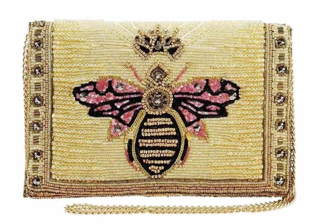 NEW! MARY FRANCES BUZZED CROSSBODY HANDBAG: NEW! MARY FRANCES BUZZED CROSSBODY HANDBAG -Bee the best dressed girl in town. Glammed out and gold- this clutch crossbody will dress up your date pm! Dimensions (W x D x H"): 8.75 x 2.5 x 6" Strap Le