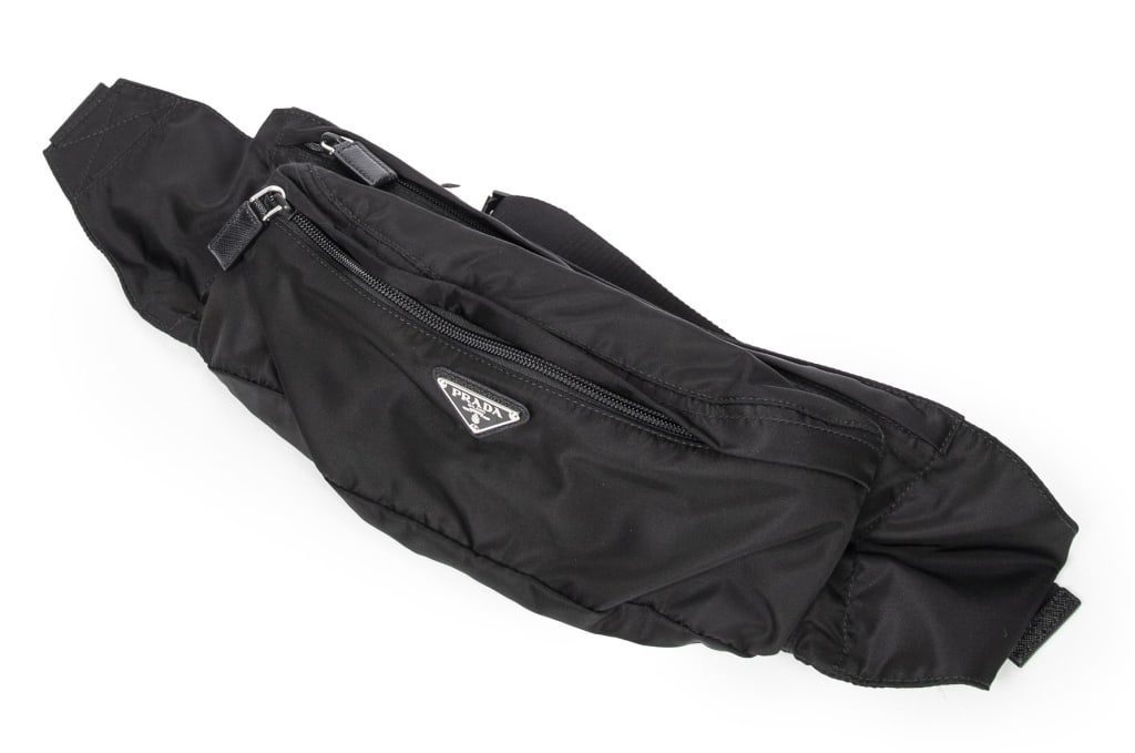 PRADA LOGO WAIST BAG BLACK: PRADA LOGO WAIST BAG BLACK CANVAS SILVER A SHOULDER BAG -BLACK -CANVAS -29*12*6,5CM -CARD -CONDITION RATING A -AAY5717 -JA 110524 ***Please note that due to limited storage space, all items must be pi