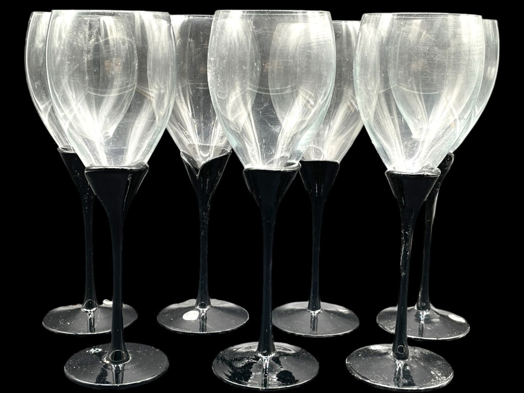 BLACK STEM WINE GLASSES SET OF 7: BLACK STEM WINE GLASSES SET OF 7 -VERY GOOD PRE OWNED CONDITION -SET OF 7 -APPROX 9" -HAND CRAFTED IN ROMANIA -JA 010325 #9 ***Please note that due to limited storage space, all items must be picked u