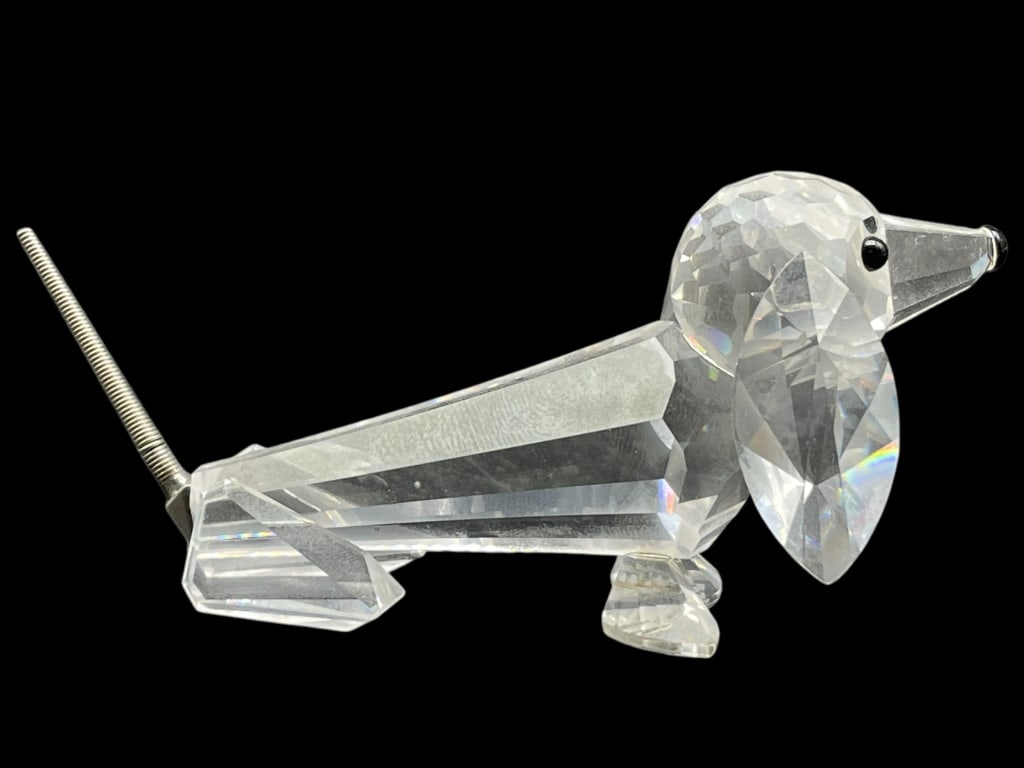SWAROVSKI CRYSTAL DACHSHUND W/ SILVER TAIL 3.5": SWAROVSKI CRYSTAL DACHSHUND W/ SILVER TAIL FIGURINE 3.5" -VERY GOOD CONDITION -APPROX 3.5" X 1.5" -SILVER TAIL -TWO OF TWO -JA 010725 FRONT ***Please note that due to limited storage space, all items 