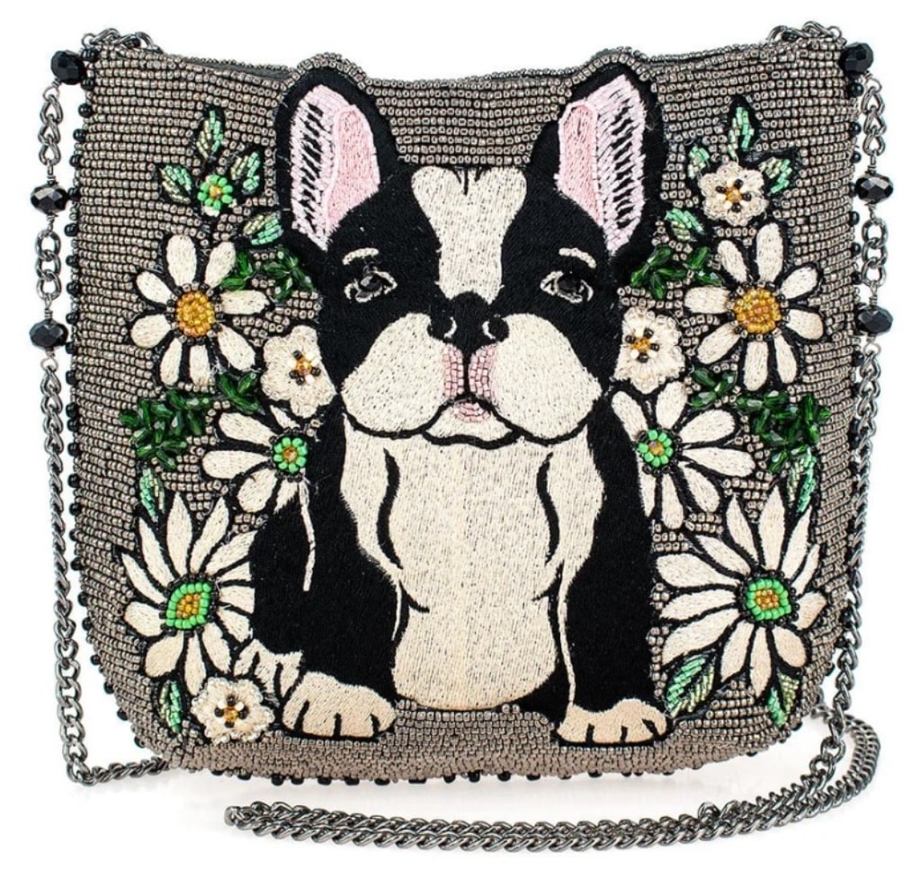 NEW! MARY FRANCES PARDON MY FRENCHY CROSSBODY: Pardon My Frenchie' is an adorable tribute to French Bulldog lovers, featuring a beautifully embroidered pup surrounded by blooming daisies. With its playful yet elegant beaded detailing, this bag cap