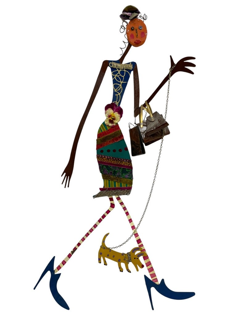 BILL FINKS FASHIONABLE METAL WALL 36": BILL FINKS FASHIONABLE METAL WALL ART – STYLISH WOMAN WALKING DOGDYNAMIC AND PLAYFUL METAL SCULPTURE DEPICTING A CHIC WOMAN IN A PATCHWORK SKIRT, HIGH HEELS, AND ACCESSORIZED WITH A PURSE AND FLORAL