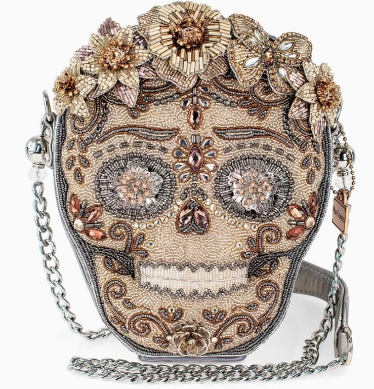 NEW! MARY FRANCES SHINING SKULL CROSSBODY HANDBAG: Indulge in luxurious style with our mixed metallics sugar skull crossbody handbag. Adorned with hand-beaded metallic florals, this statement accessory is a true work of art. Elevate any outfit and mak