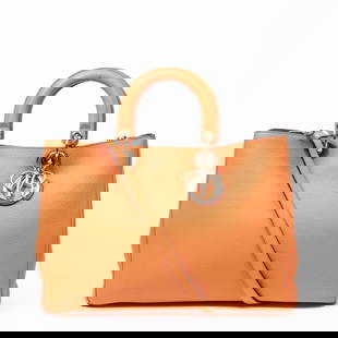 DIOR DIORISSIMO TOTE GRAINED LEATHER HANDBAG: The Diorissimo Tote embodies timeless elegance with a bold modern twist. Rendered in vibrant orange grained calfskin leather, this large-sized tote features refined dual top handles, a removable shoul