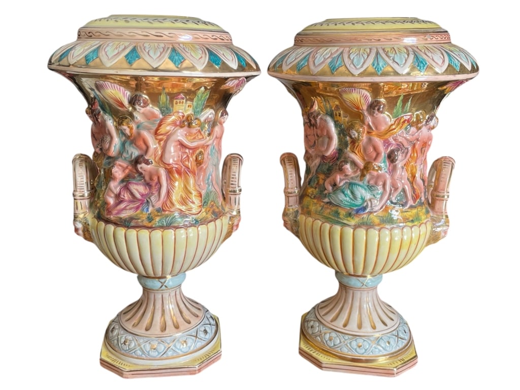 PAIR OF CAPODIMONTE ITALIAN URNS 15": PAIR OF CAPODIMONTE ITALIAN URNS 15" -VERY GOOD PRE OWNED CONDITION -APPROX 15" -HIGHLY DETAILED CLASSICAL SCENE IN RELIEF WITH VIBRANT HAND-PAINTED COLORS. INTRICATE HANDLES AND PEDESTAL BASES. STUNN