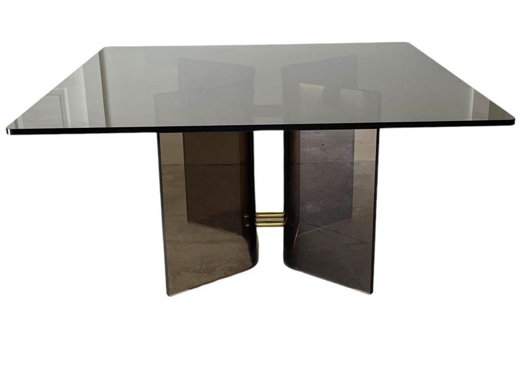 MASTERCRAFT STYLE SMOKED GLASS DINING TABLE 54": POSTMODERN MASTERCRAFT STYLE SMOKED GLASS DINING TABLE WITH BRASS ACCENT -29" X 54" X 54" APPROX -VERY GOOD PRE OWNED CONDITION -DP102324 
