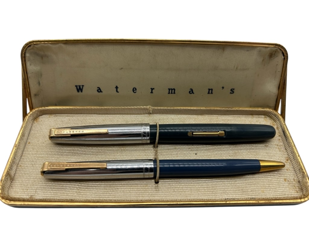 VINTAGE WATERMAN’S FOUNTAIN PEN: - WATERMAN’S VINTAGE SET INCLUDES A BLUE FOUNTAIN PEN AND MATCHING MECHANICAL PENCIL, BOTH FEATURING SLEEK CHROME CAPS WITH GOLD-TONE CLIPS. - PREOWNED VINTAGE WEAR - UNTESTED FOR FUNTIONALITY - CAS