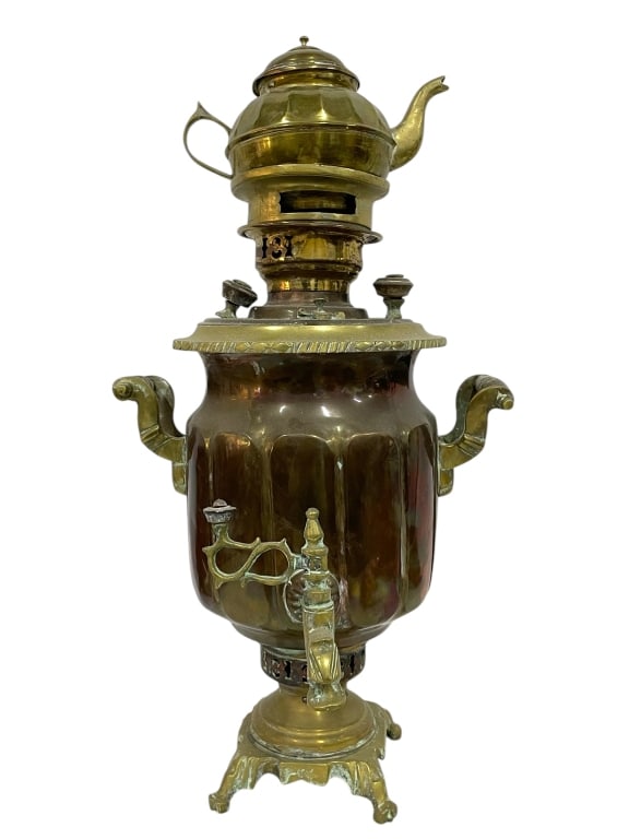 RUSSIAN BRASS SAMOVAR WITH MATCHING TEAPOT 22": RUSSIAN BRASS SAMOVAR WITH MATCHING TEAPOT 22" -GOOD PRE OWNED CONDITION, WEAR FROM AGE -APPROX 22" X 12" -FLUTED BODY DESIGN WITH ORNATE HANDLES AND SPOUT. STANDS ON DECORATIVE CLAW FEET. CLASSIC IMP