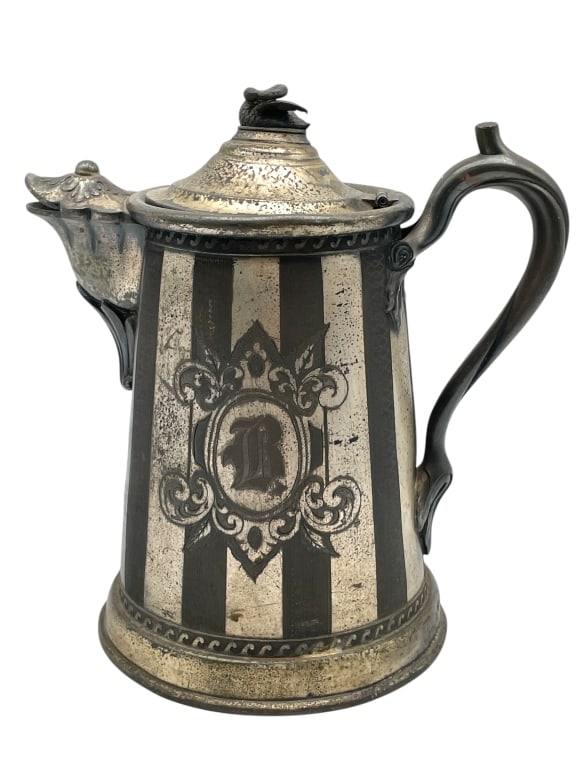VINTAGE SILVER WATER PITCHER 12": VINTAGE SILVER WATER PITCHER 12" -VERY GOOD PRE OWNED CONDITION -APPROX 12" -ORNATE ENGRAVED DESIGN WITH STRIPED PATTERN, FLORAL ACCENTS, AND MONOGRAMMED LETTER “B” -JA 041025 By bidding on th