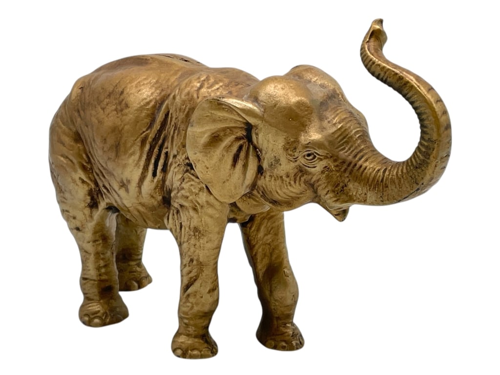 GOLD-TONE ELEPHANT SCULPTURE WITH RAISED TRUNK 9": GOLD-TONE ELEPHANT SCULPTURE WITH RAISED TRUNK 9" -VERY GOOD PRE OWNED CONDITION -APPROX 9" X 6" -ELEGANT GOLD-TONE ELEPHANT SCULPTURE WITH RAISED TRUNK – BEAUTIFULLY DETAILED CAST DESIGN WITH LIFEL