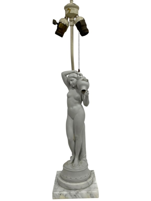 PORCELAIN WATER-BEARER LAMP W MARBLE BASE 31": WHITE BISQUE PORCELAIN WATER-BEARER FIGURAL LAMP -CLASSICAL FEMALE NUDE STATUE HOLDING A JUG, POISED GRACEFULLY ON A ROUND PEDESTAL BASE. FINISHED IN A STONE-WHITE MATTE WITH A MARBLE BASE. DUAL SOCKE