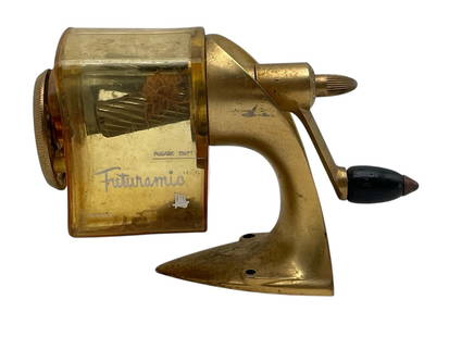 MID-CENTURY FUTURAMIC DESK PENCIL SHARPENER 6": MID-CENTURY FUTURAMIC DESK PENCIL SHARPENER 6" -VERY GOOD PRE OWNED CONDITION -APPROX 6" -FEATURES A STREAMLINED METALLIC DESIGN WITH CLEAR HOUSING TO VIEW SHAVINGS, HAND-CRANK MECHANISM, AND STURDY B