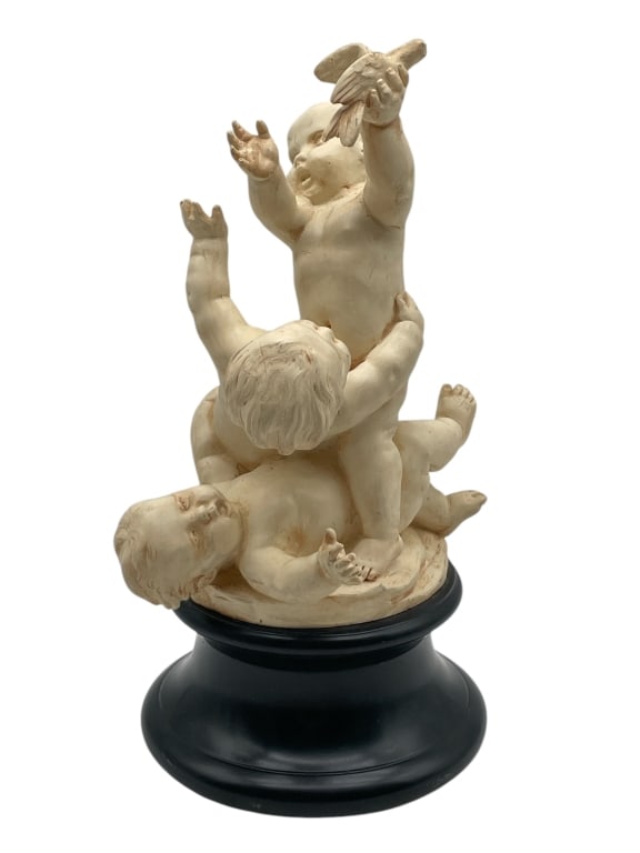 THOMAS BLAKEMORE CHERUB FIGURINE SCULPTURE 13": THOMAS BLAKEMORE CHERUB FIGURINE SCULPTURE 13" -VERY GOOD PRE OWNED CONDITION -APPROX 13" -FEATURES THREE PLAYFUL PUTTI IN DYNAMIC POSES, ONE HOLDING A BIRD, ALL SET ON A RAISED BLACK BASE -JA 042425 