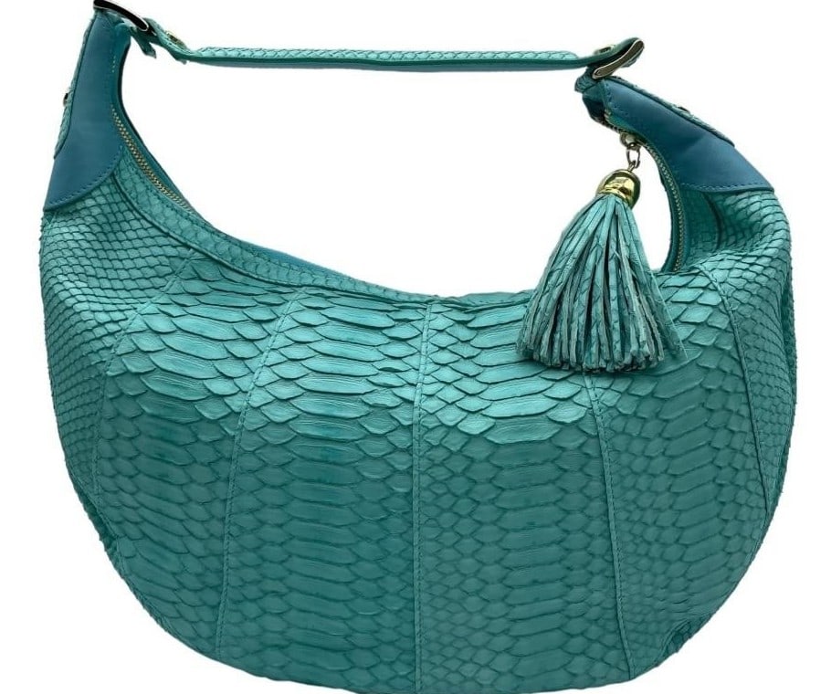 LALO TURQUOISE SNAKE SKIN LEATHER HANDBAG: LALO TURQUOISE SNAKE SKIN LEATHER HANDBAG -VERY GOOD CONDITION -APPROX 15" X 16" -FEATURES LUXURIOUS SCALE TEXTURE, GOLD HARDWARE, AND A MATCHING LEATHER TASSEL CHARM. A BOLD AND ELEGANT STATEMENT PIE