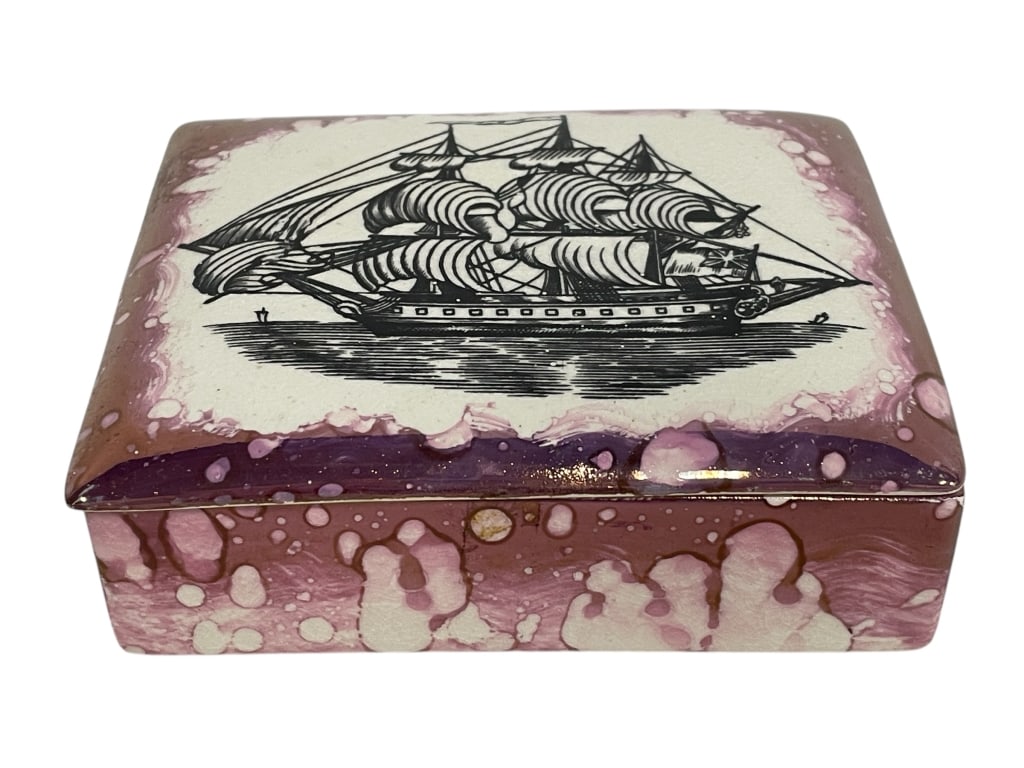 GARY'S POTTERY SAILING SHIP TRINKET BOX 4.5": GARY'S POTTERY SAILING SHIP TRINKET BOX 4.5" -VERY GOOD PRE OWNED CONDITION -APPROX 4.5" -FEATURES A BLACK AND WHITE IMAGE OF A TALL SHIP ON THE LID, SURROUNDED BY A PINK LUSTER SPLATTER GLAZE. PERFEC