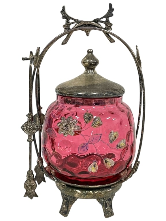 CRANBERRY GLASS PICKLE CASTOR 8.5": CRANBERRY GLASS PICKLE CASTOR 8.5" -VERY GOOD PRE OWNED CONDITION -APPROX 8.5" X 5" -RICH CRANBERRY GLASS INSERT WITH RAISED THUMBPRINT PATTERN AND HAND-PAINTED ENAMELED FLORAL MOTIF. ORNATE SILVER FR