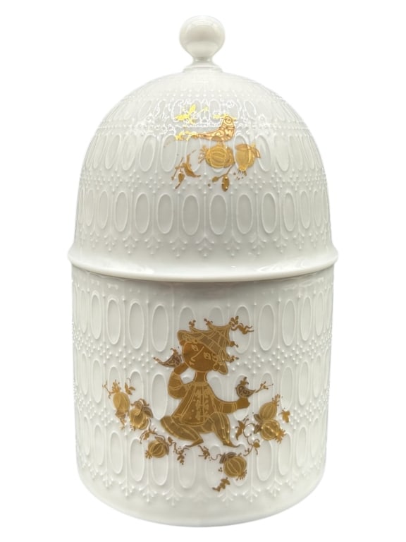 ROSEN THAL STUDIO-LINIE PORCELAIN COVERED JAR 6.5": - DESIGNED BY BJØRN WIINBLAD FOR THE “ROMANZE” COLLECTION, THIS DELICATELY EMBOSSED WHITE PORCELAIN JAR FEATURES WHIMSICAL 22K GOLD GRAPHICS OF A CHILD FIGURE AND BIRD MOTIFS. THE SCULPTURAL 