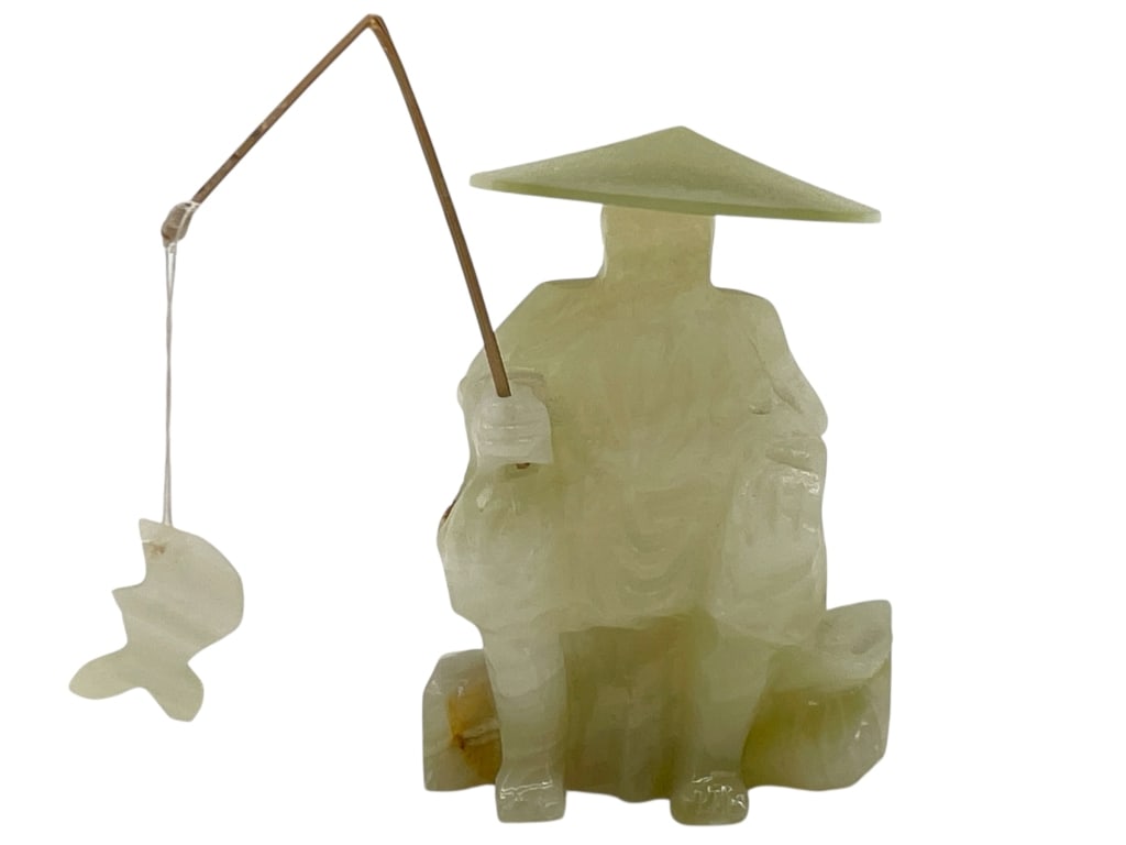 CARVED STONE FIGURE OF A FISHERMAN 4": CARVED STONE FIGURE OF A FISHERMAN 4" -VERY GOOD PRE OWNED CONDITION -APPROX 4" X 3.5" -FEATURES A STYLIZED SEATED FISHERMAN WEARING A TRADITIONAL CONICAL HAT AND HOLDING A FISHING POLE WITH A SUSPEND