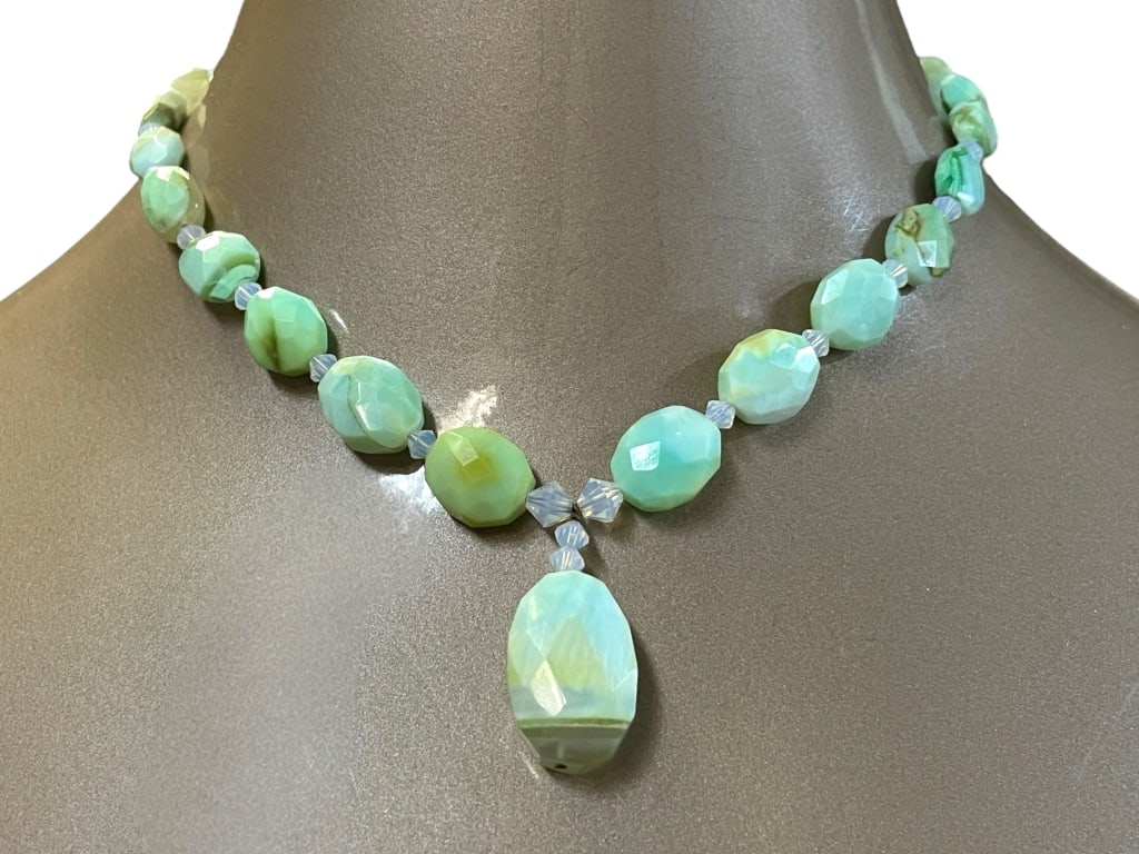 AQUA BEAD NECKLACE WITH CENTER DROP: AQUA BEAD NECKLACE WITH CENTER DROP -VERY GOOD PRE OWNED CONDITION -LOVELY MINT GREEN TO AQUA VARIATIONS IN NATURAL OPAL STYLE STONES, ACCENTED WITH FACETED CRYSTAL SPACERS AND CENTER DROP PENDANT. -J