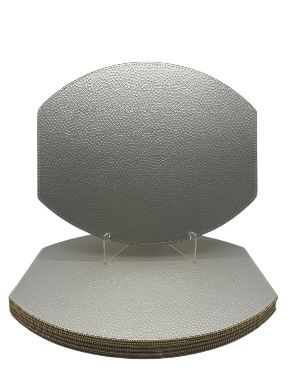 SET OF 10 METALLIC FAUX LEATHER PLACEMATS 15": - STYLISH AND DURABLE, THIS SET FEATURES A UNIQUE HALF-OCTAGON SHAPE WITH A TEXTURED PEBBLE GRAIN FINISH IN A METALLIC SILVER TONE. FINISHED WITH A BEADED EDGE TRIM FOR ADDED ELEGANCE. PERFECT FOR CON