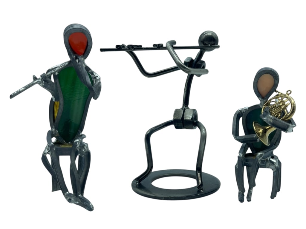 3 METAL FIGURES PLAYING MUSICAL INSTRUMENTS, 5.5": 3 METAL SCULPTURES – WHIMSICAL ABSTRACT FIGURES PLAYING MUSICAL INSTRUMENTS INCLUDING FLUTE, FRENCH HORN, AND PAN FLUTE. - GOOD PRE-OWNED CONDITION - 5.5" H APPROX - HANDCRAFTED FROM WROUGHT METAL,