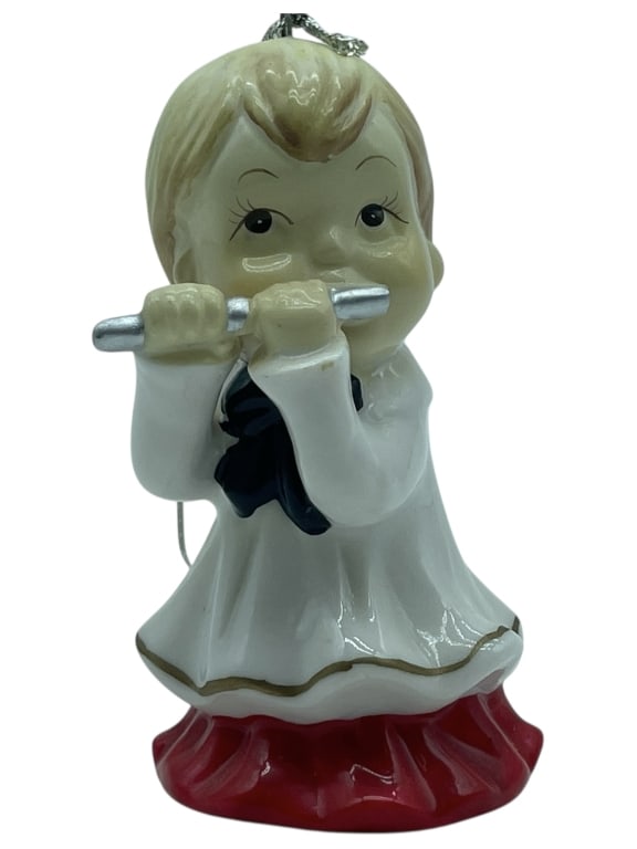 VINTAGE PORCELAIN CHRISTMAS ORNAMENT, 3.5": VINTAGE PORCELAIN CHRISTMAS ORNAMENT - IN VERY GOOD PRE-OWNED CONDITION - 3.5" H X 2" W APPROX - FEATURES A CHARMING CHILD FIGURINE PLAYING A FLUTE, DRESSED IN A WHITE ROBE WITH RED HEM AND NAVY BOW.