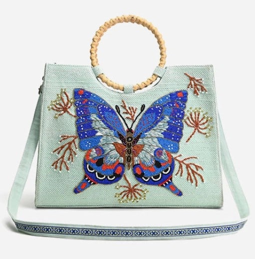 NEW! AMERICA AND BEYOND BUTTERLY TOTE: * Handheld Tote * Bamboo Top Handle * Hand Embellished Beadwork * Beaded Butterfly in Front * Long Adjustable Crossbody Strap with Lace Detailing * Magnetic Button Closure * Made in Hand-Woven Jacquar