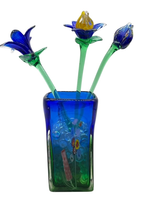 MURANO STYLE GLASS FLOWER BOUQUET IN VASE: MURANO STYLE GLASS FLOWER BOUQUET SCULPTURE IN VASE – THIS WHIMSICAL ART GLASS ARRANGEMENT FEATURES THREE HAND-BLOWN FLOWERS IN VIBRANT SHADES OF COBALT, GREEN, YELLOW, AND PURPLE, EACH WITH INTRICA