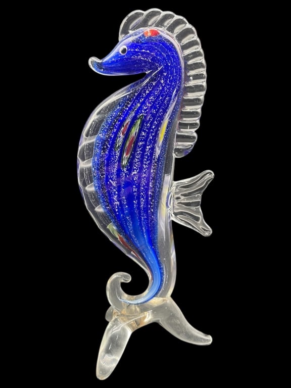 MURANO STYLE ART GLASS SEAHORSE SCULPTURE 10": - HAND-BLOWN ART GLASS SEAHORSE WITH VIBRANT COBALT BLUE BODY, COLORFUL MILLEFIORI-LIKE ACCENTS, AND CLEAR FINNED DETAILS– STANDS ON A SCROLLING CLEAR GLASS BASE, DISPLAYING FINE CRAFTSMANSHIP AND W