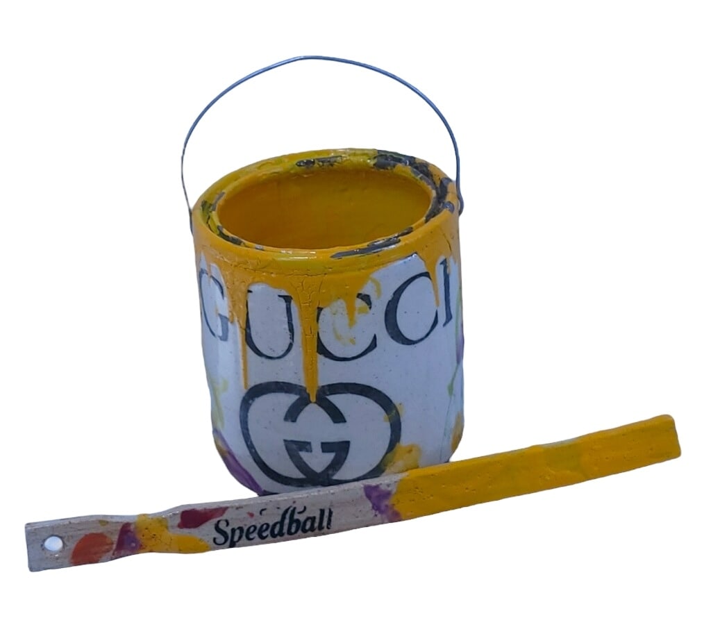 RAY GROSS “GUCCI?? PAINT CAN SCULPTURE 6.5": A LUXURIOUS AND PLAYFUL WORK BY CONTEMPORARY ARTIST RAY GROSS, THIS SCULPTURE TRANSFORMS A SIMPLE PAINT CAN INTO A HIGH-FASHION ICON. CRAFTED FROM FINE PORCELAIN AND EMBELLISHED WITH 23K GOLD AND PLAT