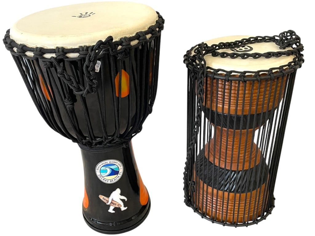 PAIR OF PERCUSSION DRUMS: PAIR OF PERCUSSION DRUMS | INCLUDES ONE DJEMBE DRUM AND ONE TALKING DRUM, BOTH FEATURING ROPE-TUNED NATURAL SKINHEADS. THE DJEMBE, WITH ITS GOBLET SHAPE, HAS A BLACK FINISH ADORNED WITH ORANGE ACCENTS