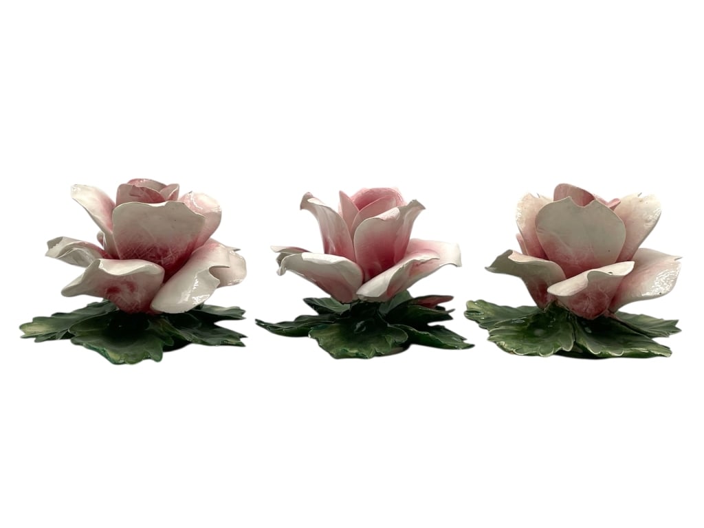 CAPODIMONTE PORCELAIN PINK ROSE FIGURINES: THREE CAPODIMONTE PORCELAIN PINK ROSE BLOSSOM FIGURINES_x005F -VERY GOOD PRE OWNED CONDITION_x005F -APPROX 4" X 4"_x005F -PORCELAIN PINK ROSE BLOSSOM FIGURINES WITH GREEN LEAVES. EACH HAND-PAINTED AND