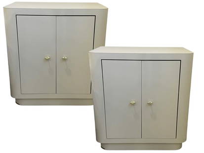 PAIR OF MODERN CREAM LACQUERED NIGHTSTANDS: PAIR OF MODERN CREAM LACQUERED NIGHTSTANDS – EACH NIGHTSTAND FEATURES A SLEEK CONTEMPORARY DESIGN WITH ROUNDED EDGES, TWO CABINET DOORS, AND ELEGANT BRASS/GOLD-TONE KNOBS. FINISHED IN A HIGH-GLOSS L