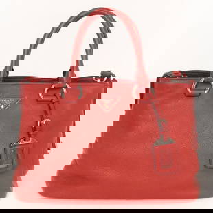 PRADA RED PEBBLED LEATHER TOTE BAG: PRADA RED PEBBLED LEATHER TOTE BAG WITH SILVER-TONE HARDWARE – THIS ELEGANT PRADA TOTE IS CRAFTED FROM LUXURIOUS RED PEBBLED LEATHER AND FEATURES THE ICONIC PRADA LOGO PLAQUE ON THE FRONT. DESIGNED